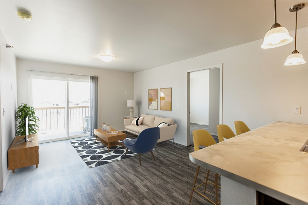 a living room and dining room with a couch and a table and a kitchen