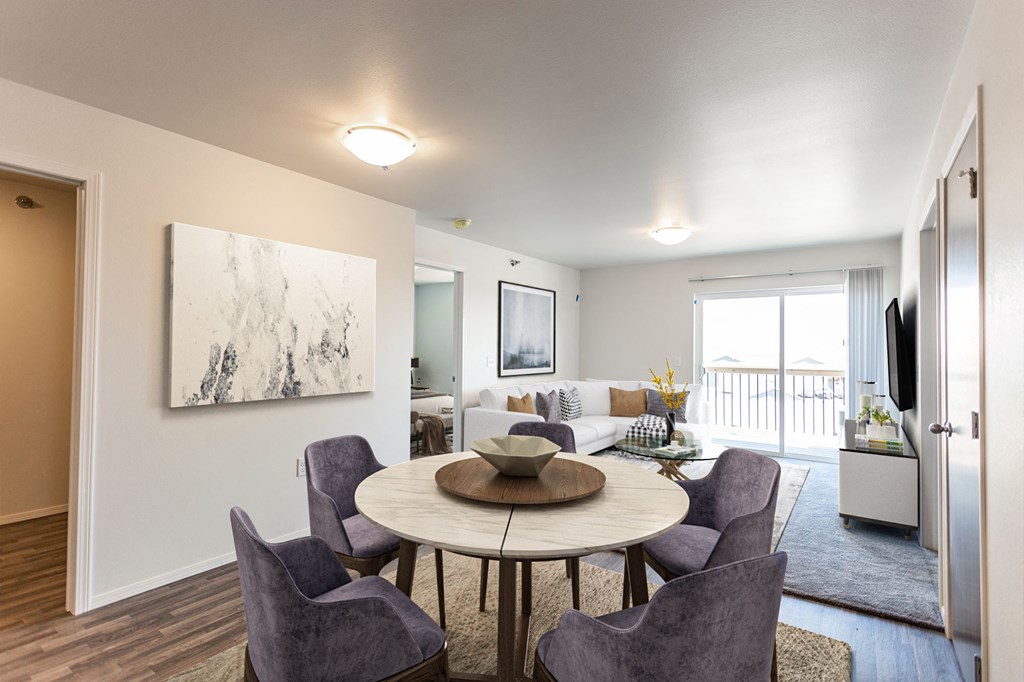 an open living room and dining room with a table and chairs