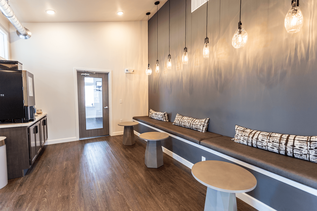 a seating area with benches and a tv in a room