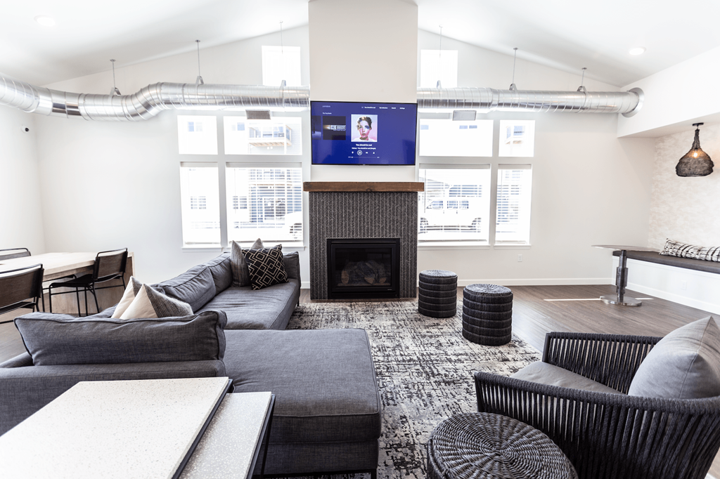 a living room with couches and chairs and a fireplace