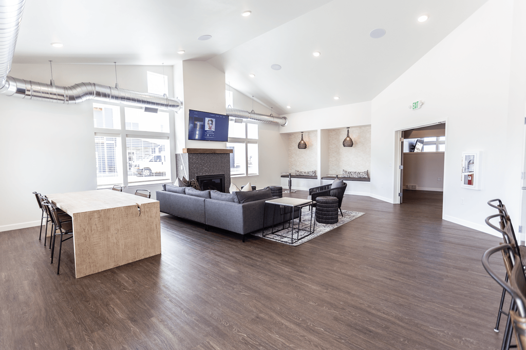 a living room with a couch and a table     and a kitchen