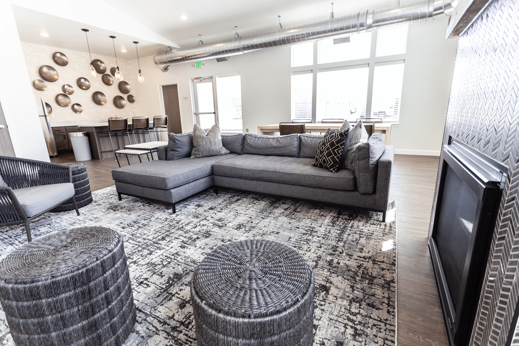 a living room with couches and chairs and a television