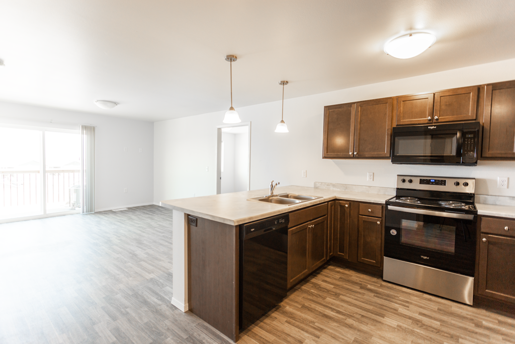 A kitchen with wooden cabinets and stainless steel appliances.