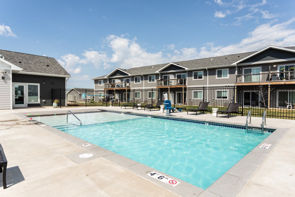 a swimming pool with apartments in the background