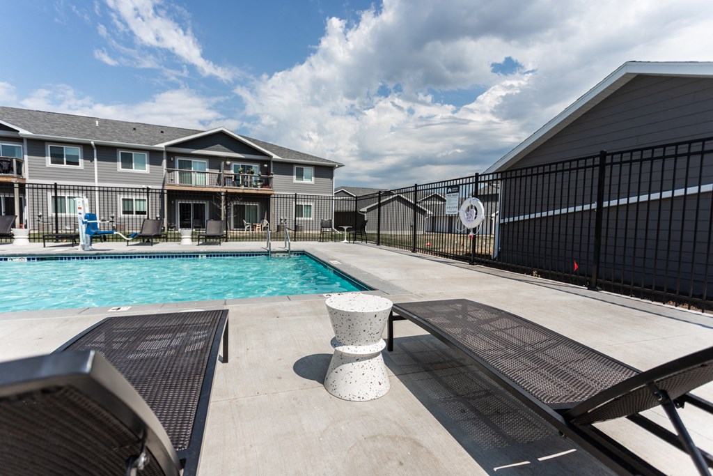 our apartments have a resort style pool with lounge chairs and tables