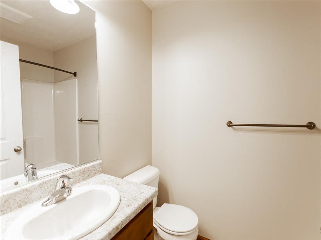 a bathroom with a sink toilet and a mirror