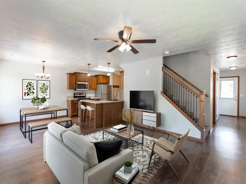 a living room with a couch and a ceiling fan