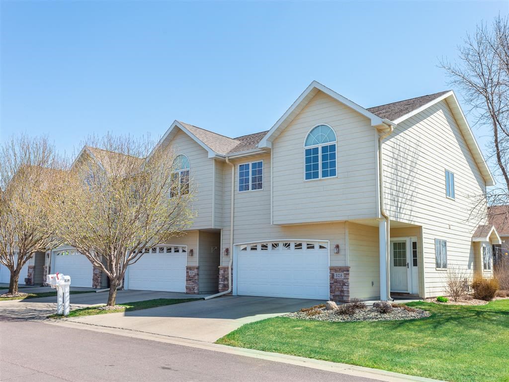 a white house with a driveway and a garage door