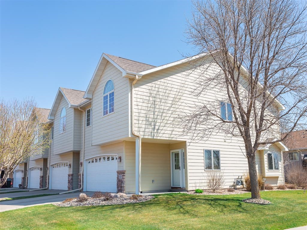 a white house with a tree in front of it