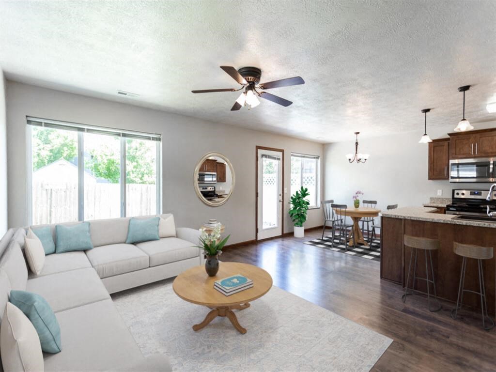 a living room and kitchen with a couch and a table