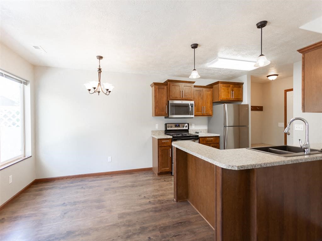 a kitchen with wooden cabinets and a counter top