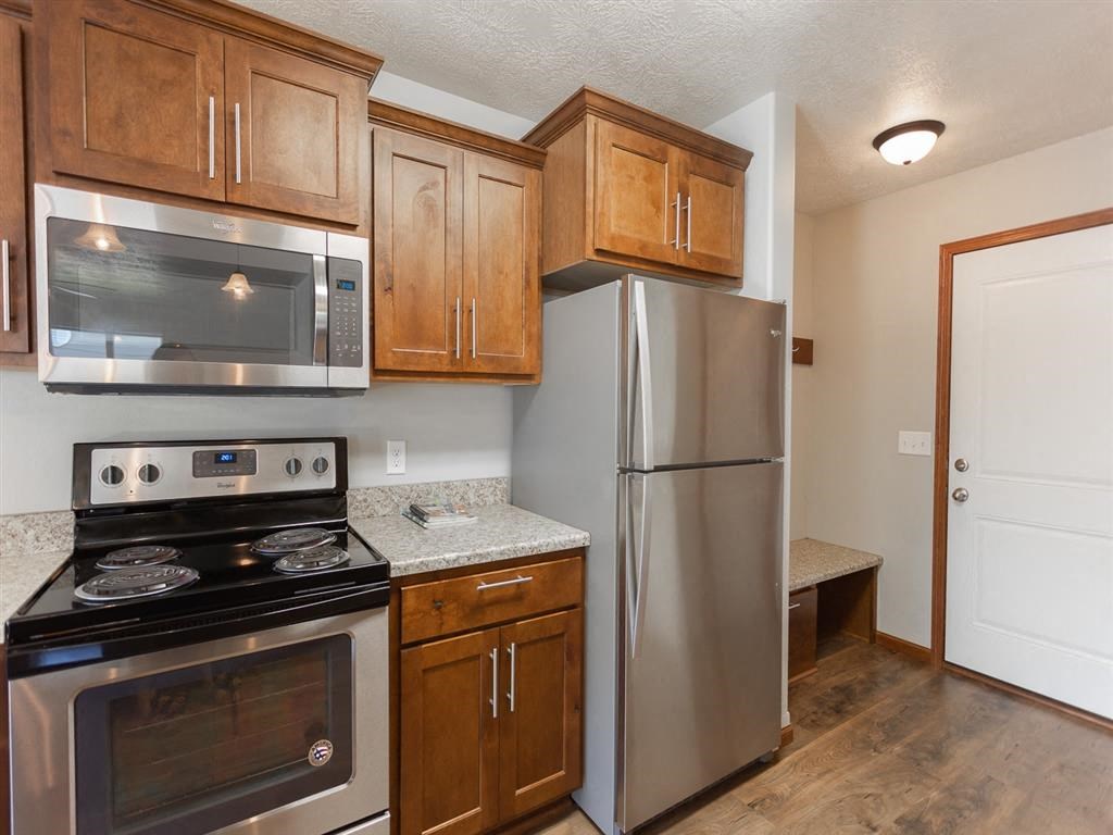 a kitchen with stainless steel appliances and wooden cabinets