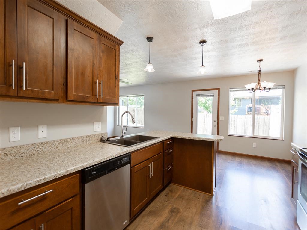 a kitchen with wooden cabinets and a sink