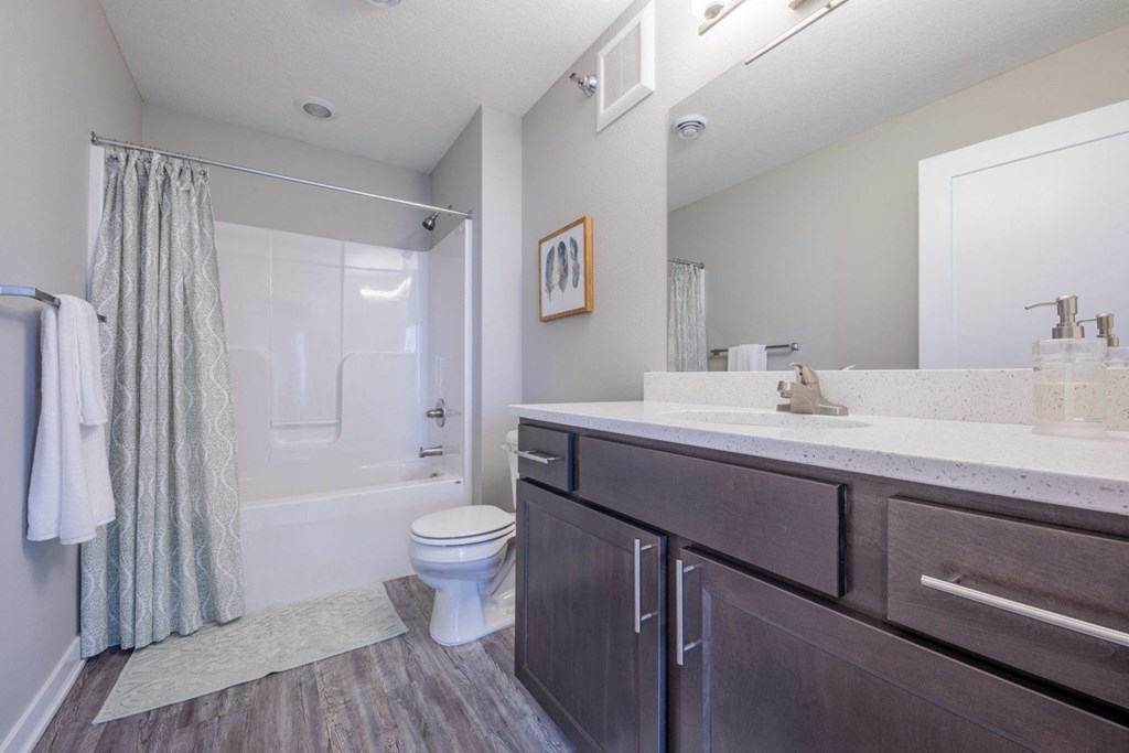 a bathroom with a shower and a sink and a toilet