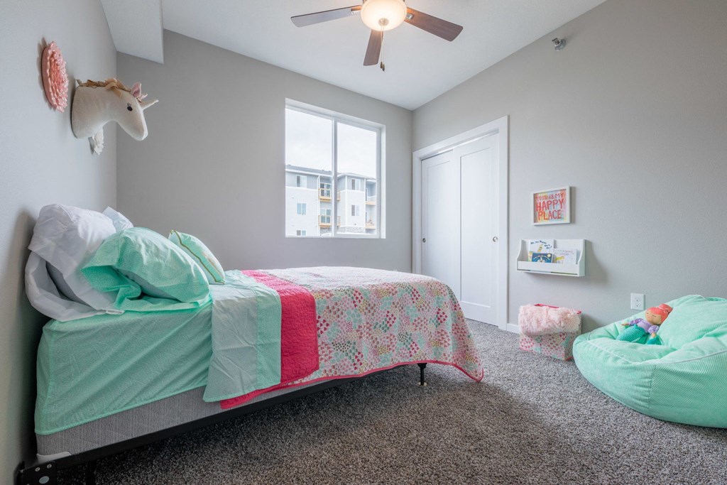 a bedroom with a bed and a ceiling fan