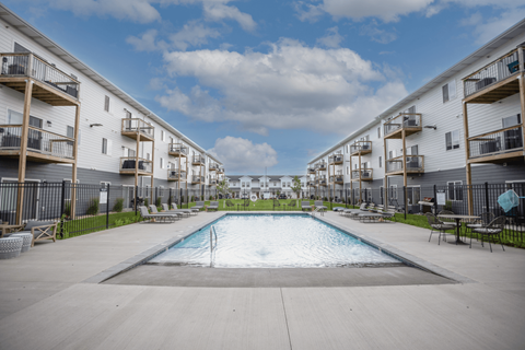 A swimming pool in the middle of apartment buildings.