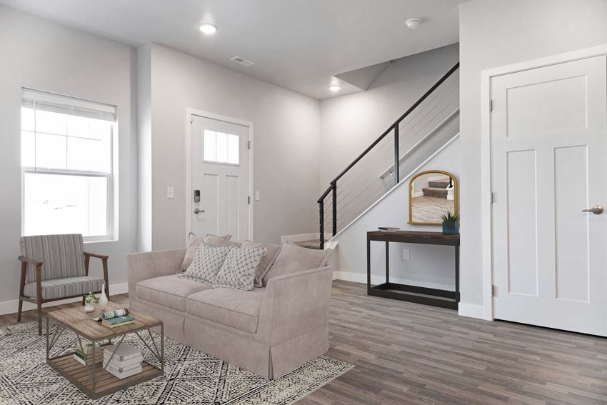 the living room of a new home with a couch and a staircase