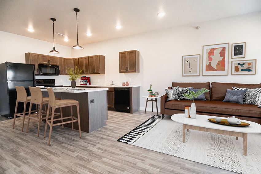 a living area with a kitchen and a couch and a table