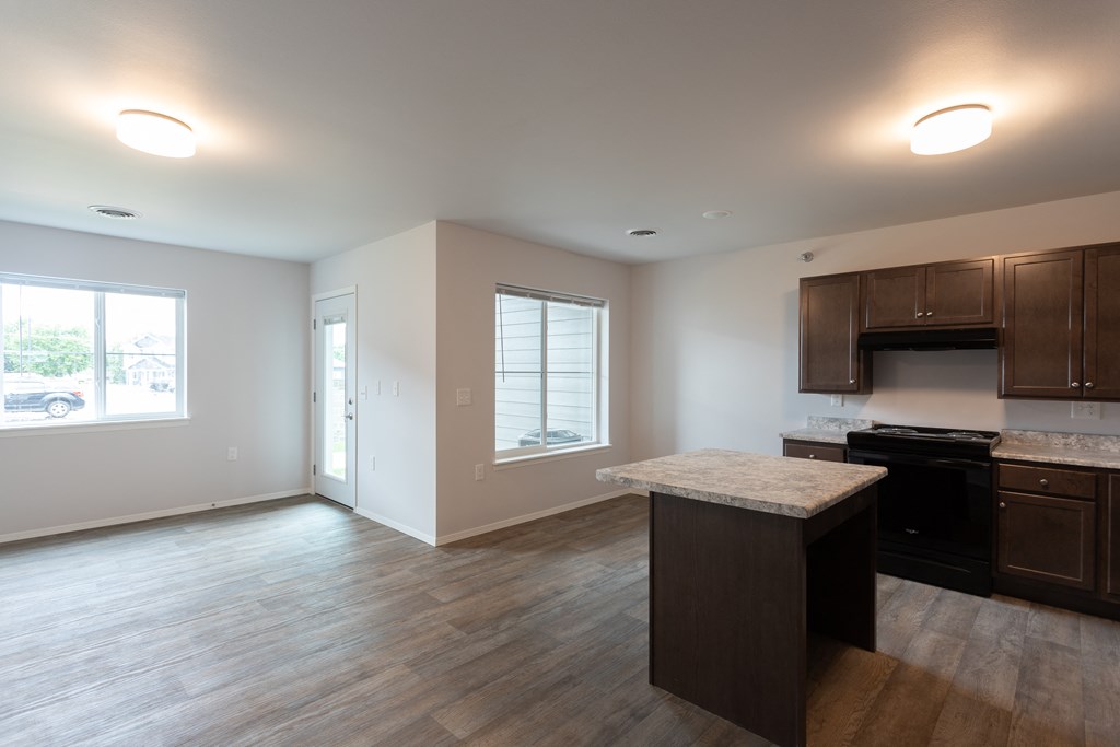 an empty kitchen with an island in the middle of it