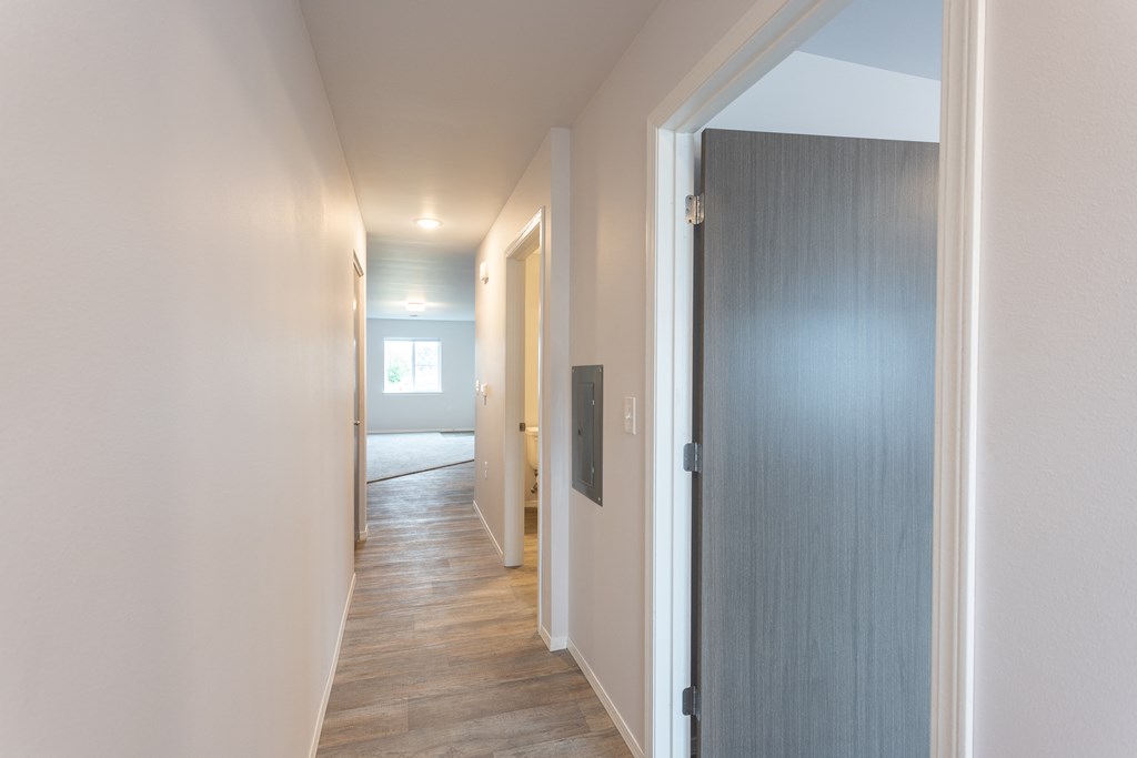 a hallway with a door to a bedroom and a bathroom
