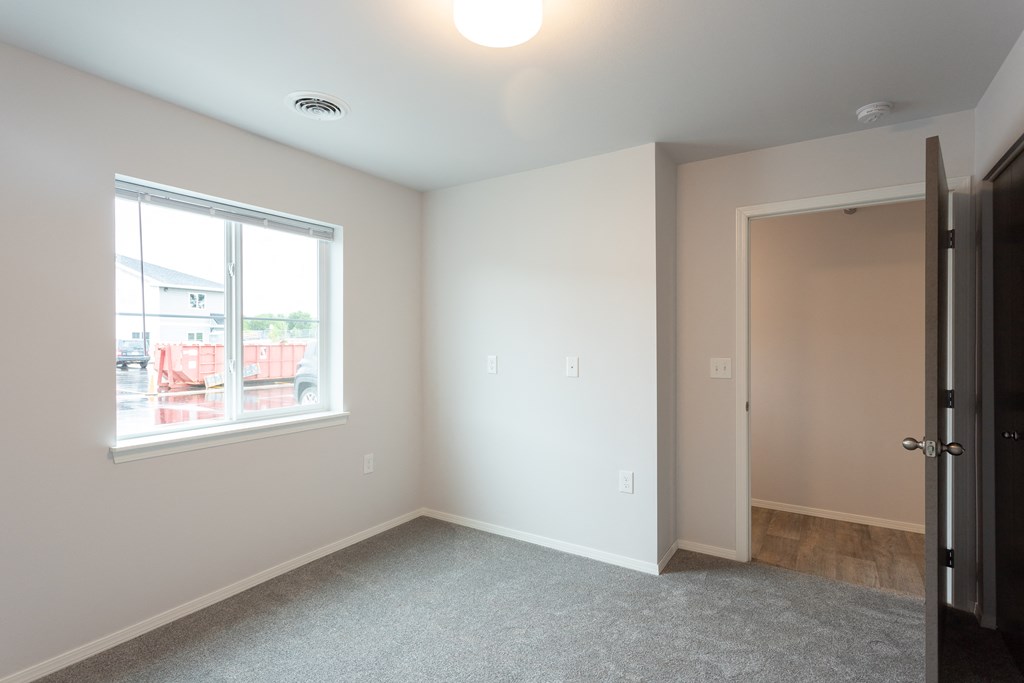 an empty room with a window and a door