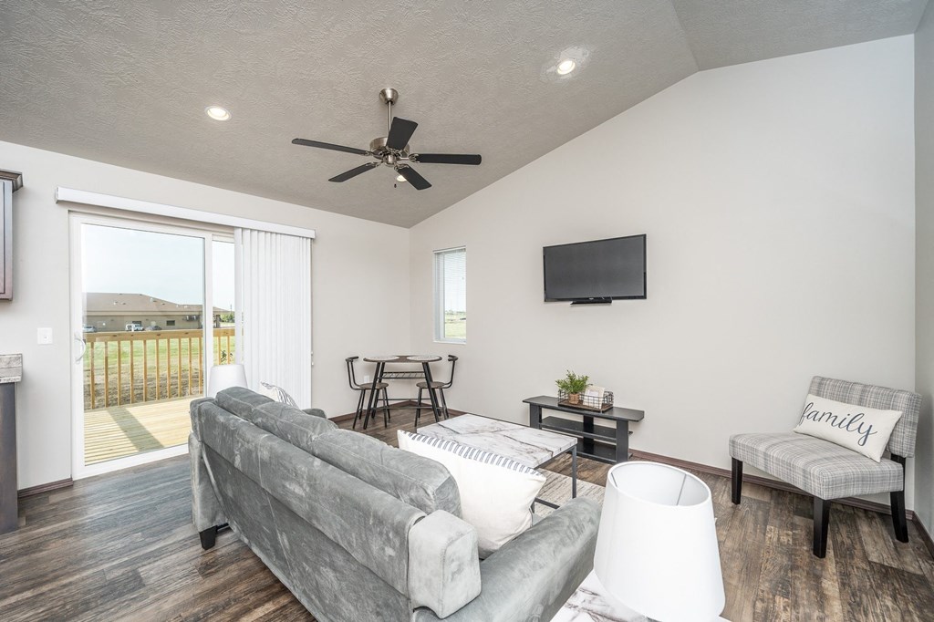 a living room with a couch and a ceiling fan