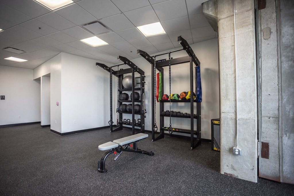 a fitness room with weights and equipment in a building
