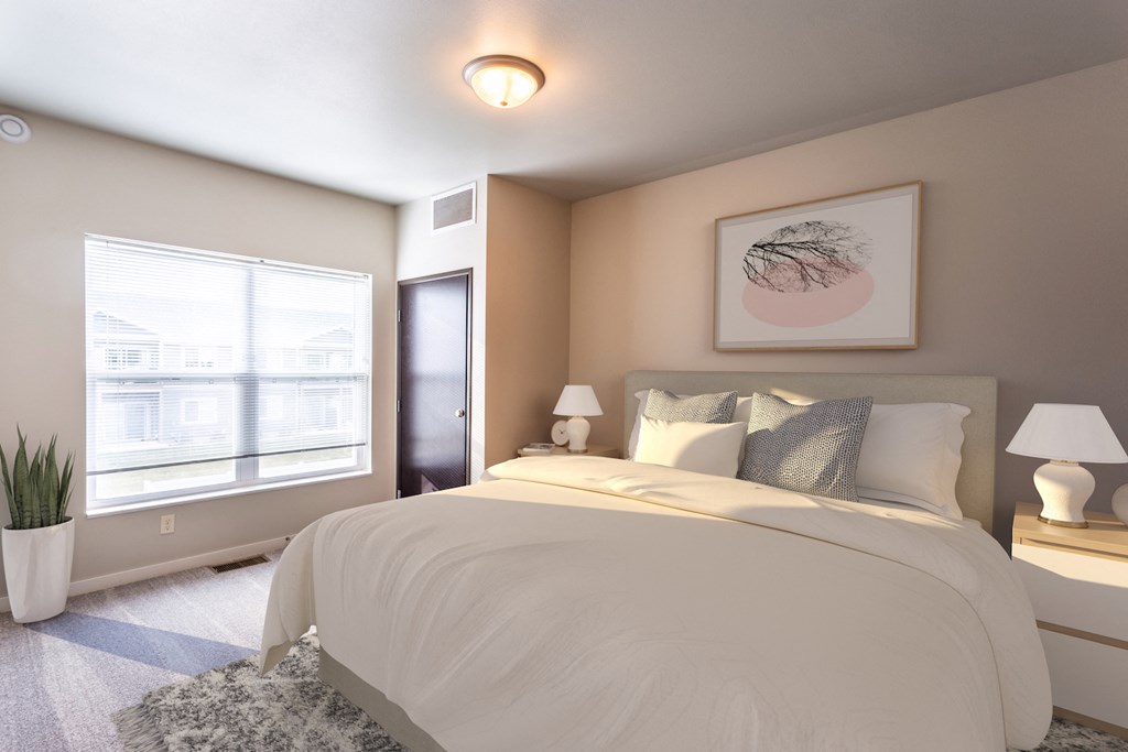 a bedroom with a large bed and a window