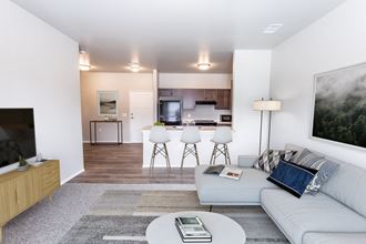 a living room and kitchen with a couch and a table