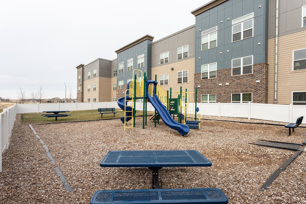our apartments have a playground with a picnic table