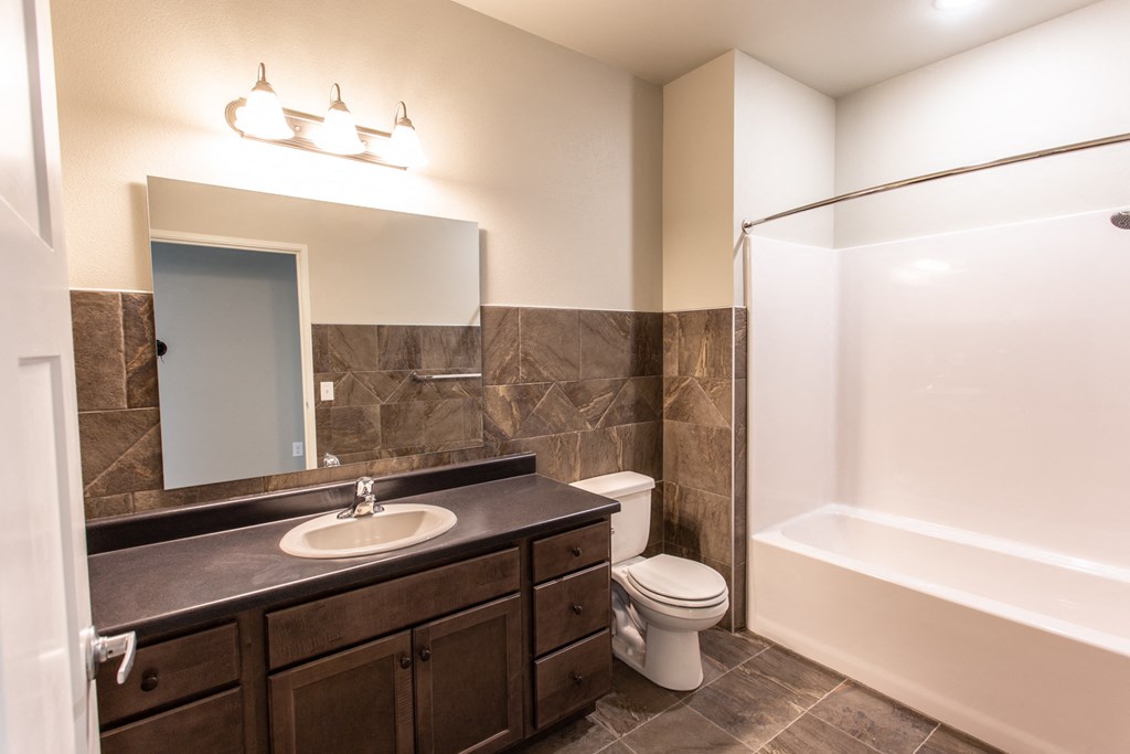 a bathroom with a sink toilet and a bath tub