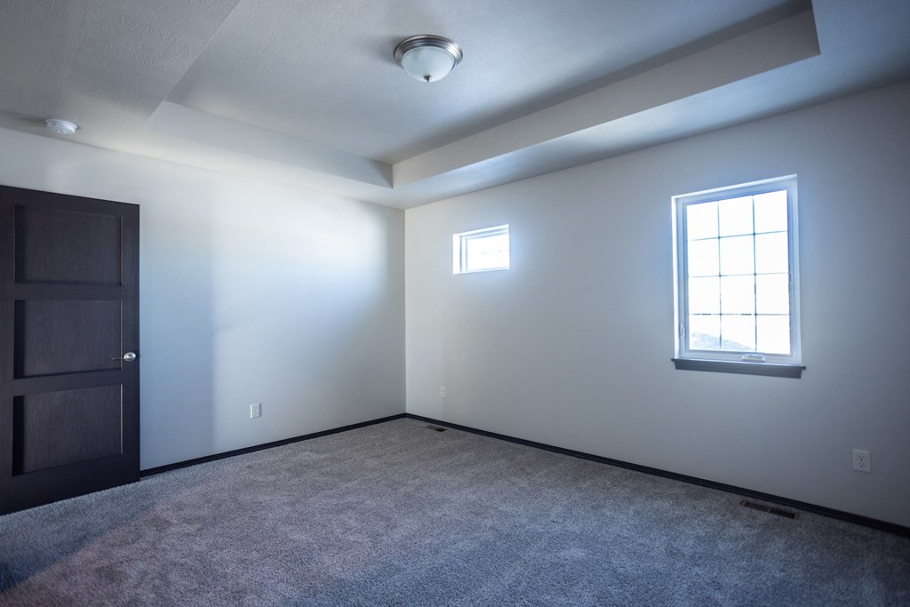 an empty room with a window and a door