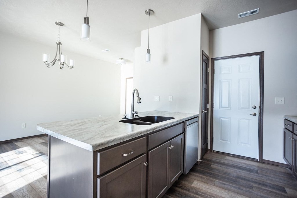 a kitchen with a large counter top and a sink
