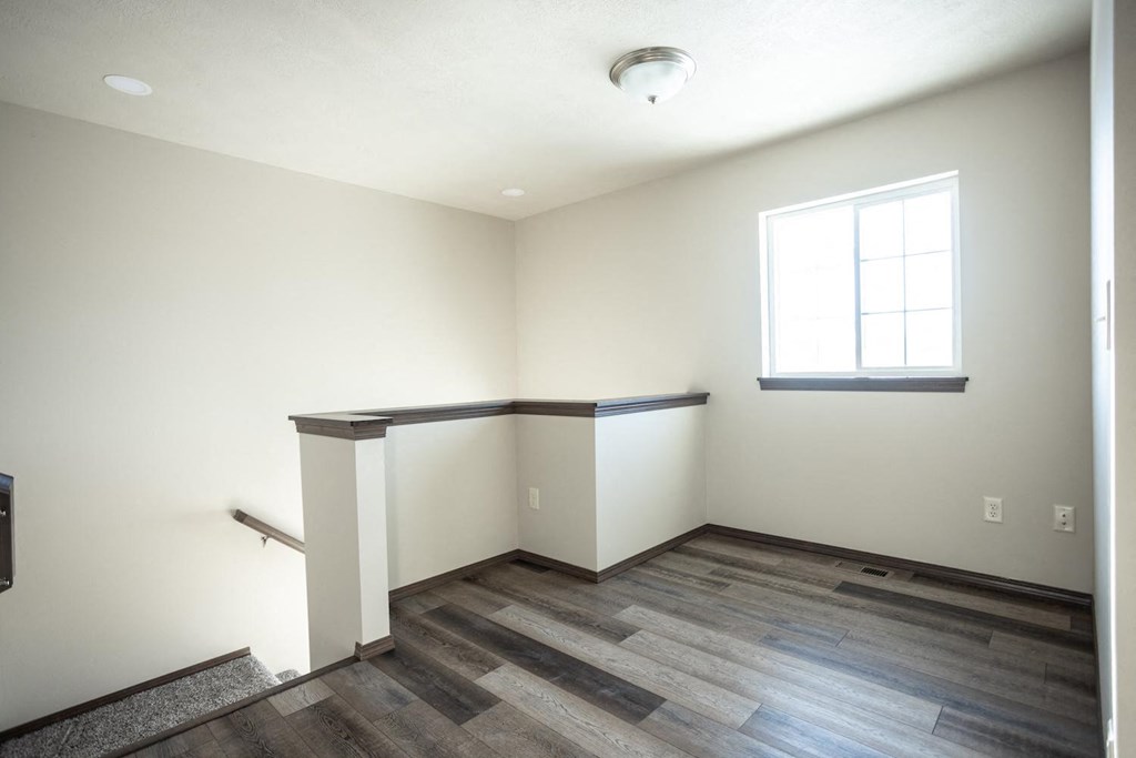 a room with hard wood floors and a window