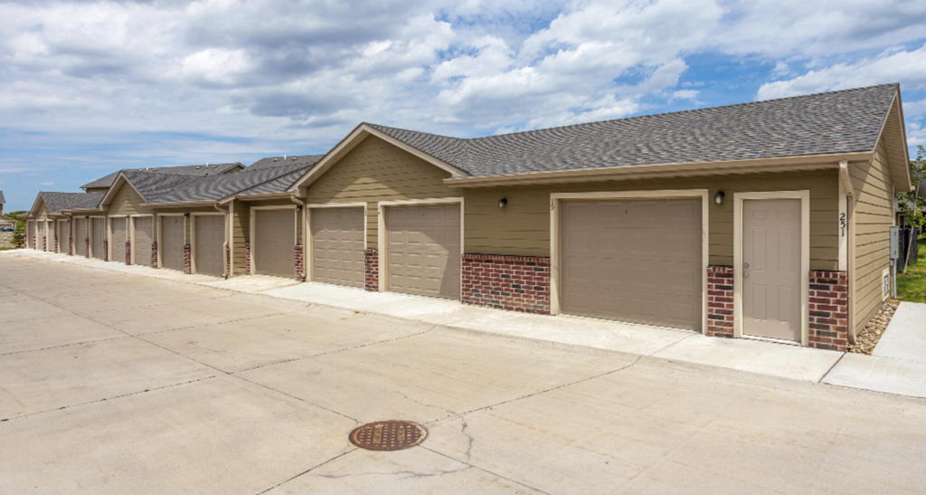 Apartment complex with swimming pool and surrounding greenery.