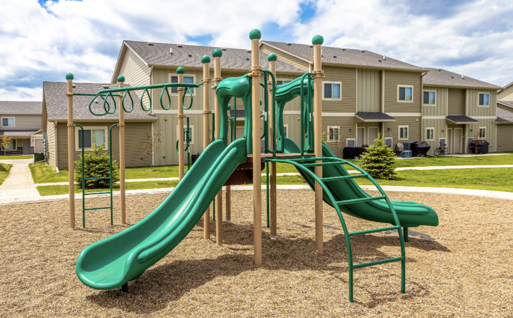 Apartment complex with swimming pool and surrounding greenery.