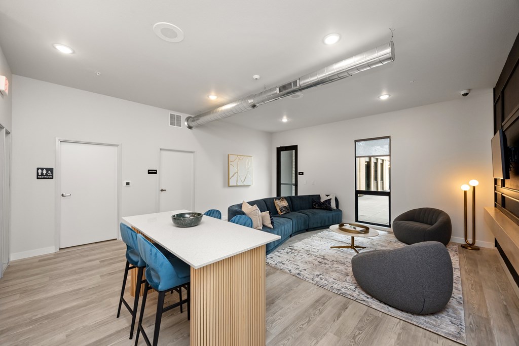 A modern living room with a dining table and a couch.
