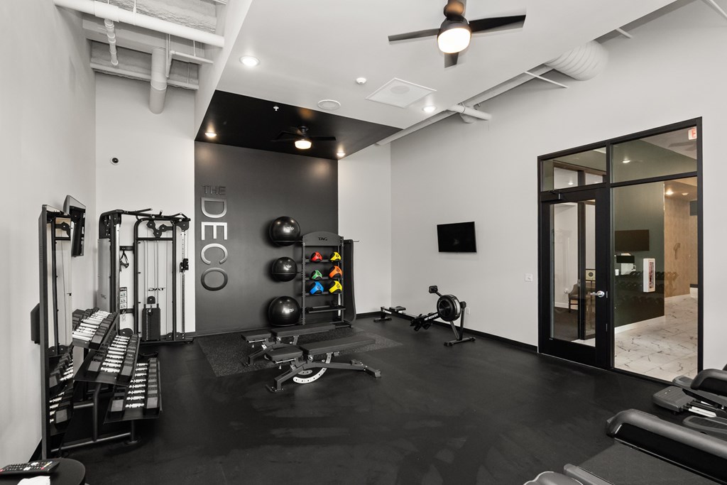 A black and white gym with a variety of equipment.