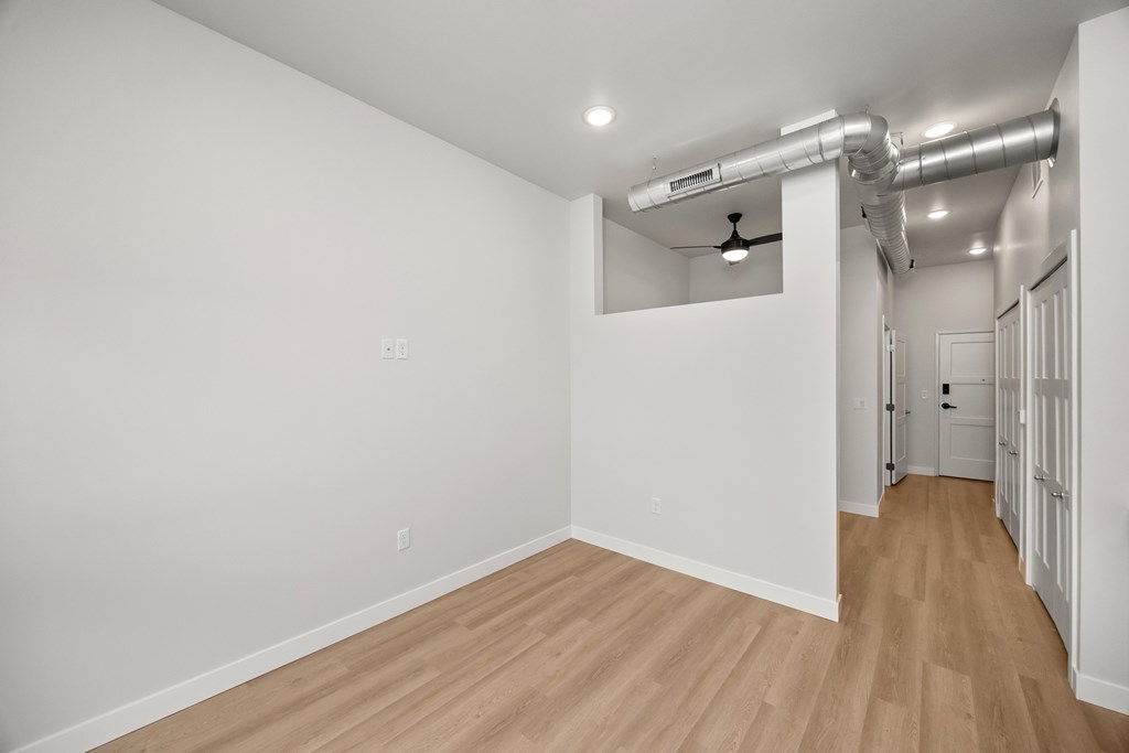 A room with wooden floors and white walls.