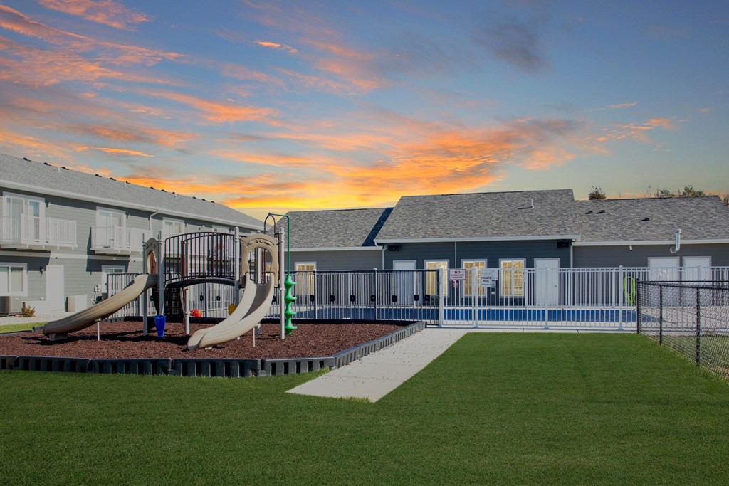 a playground at sunset in front of a building