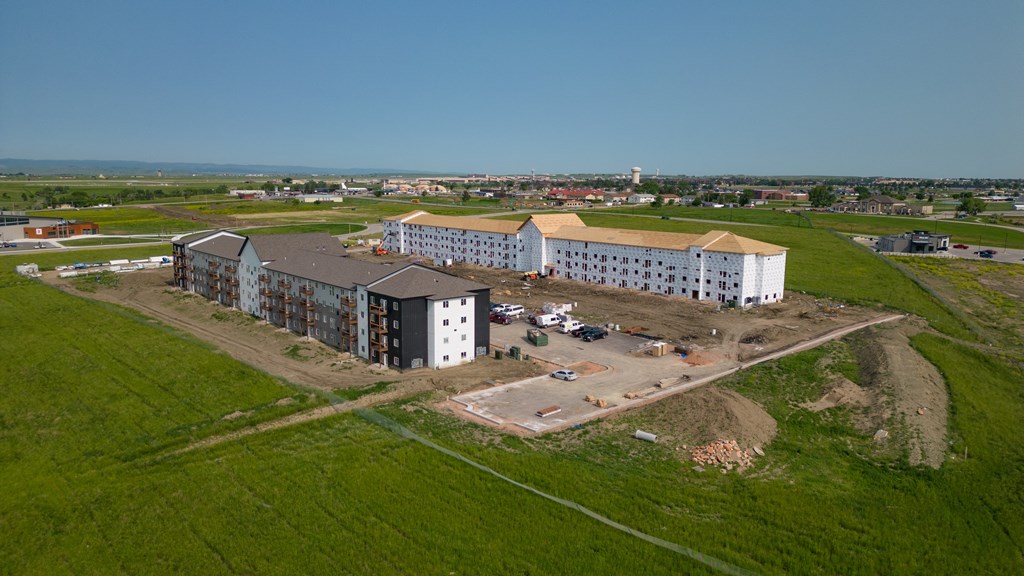 an aerial view of several buildings and a field