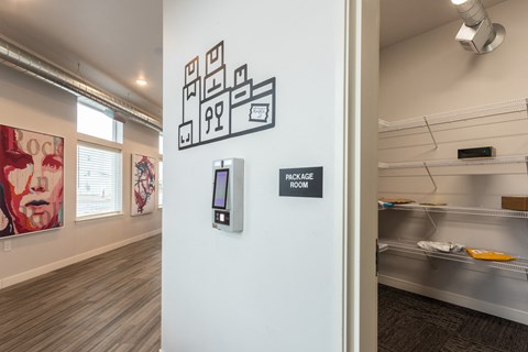a hallway with a white wall with a button on it and a wall mounted phone