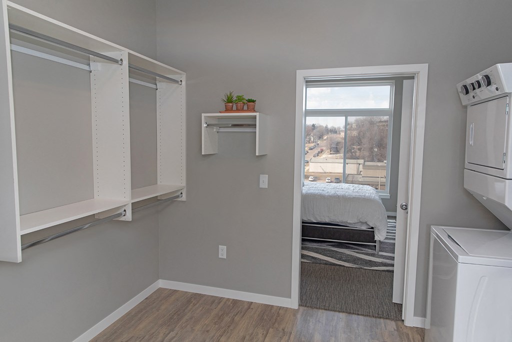 an empty kitchen with a bedroom in the background