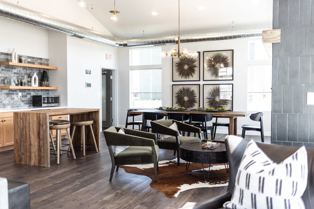 a living room with a table and chairs and a kitchen