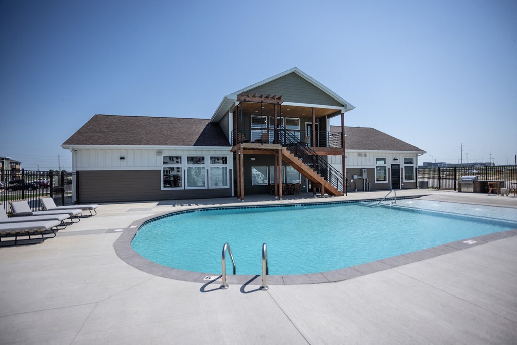 a swimming pool with a house in the background