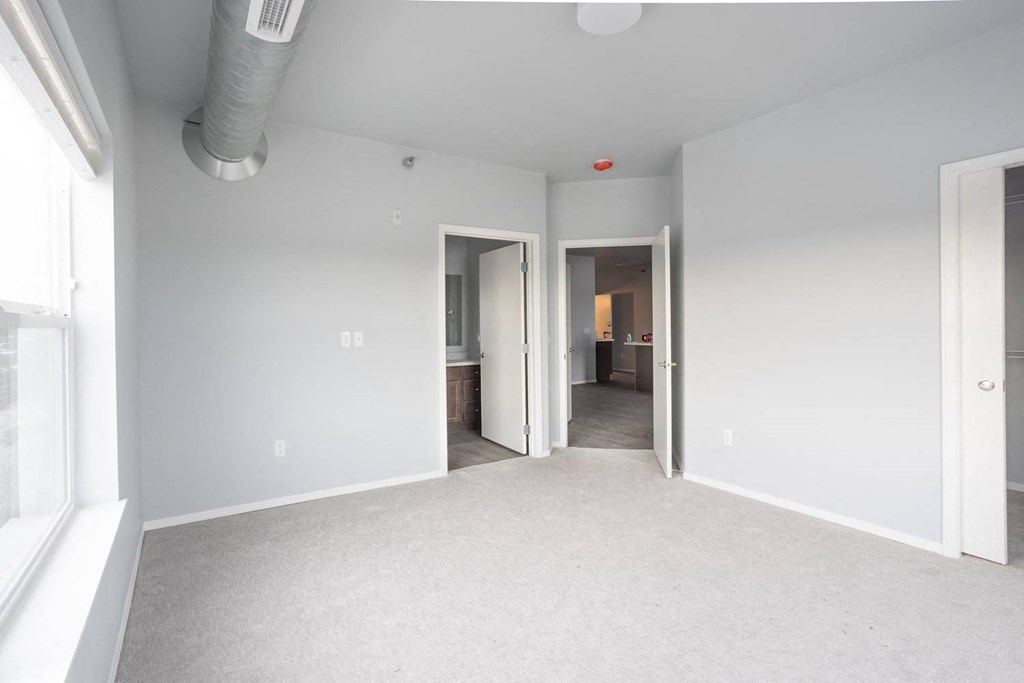 a living room with white walls and a white carpet