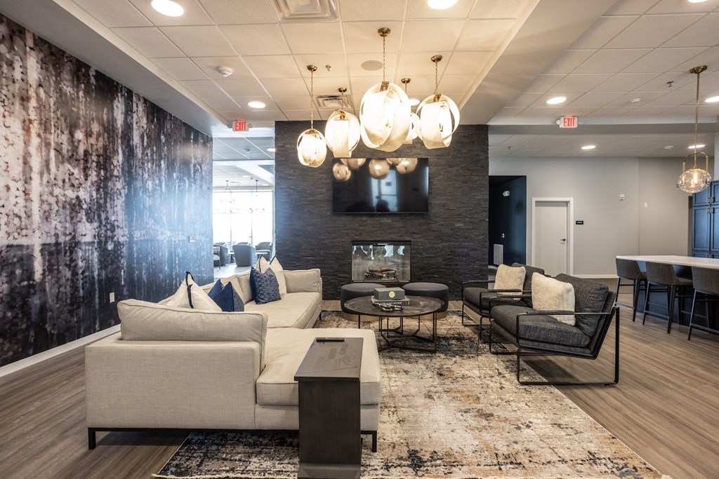 a living room with couches and chairs and a fireplace