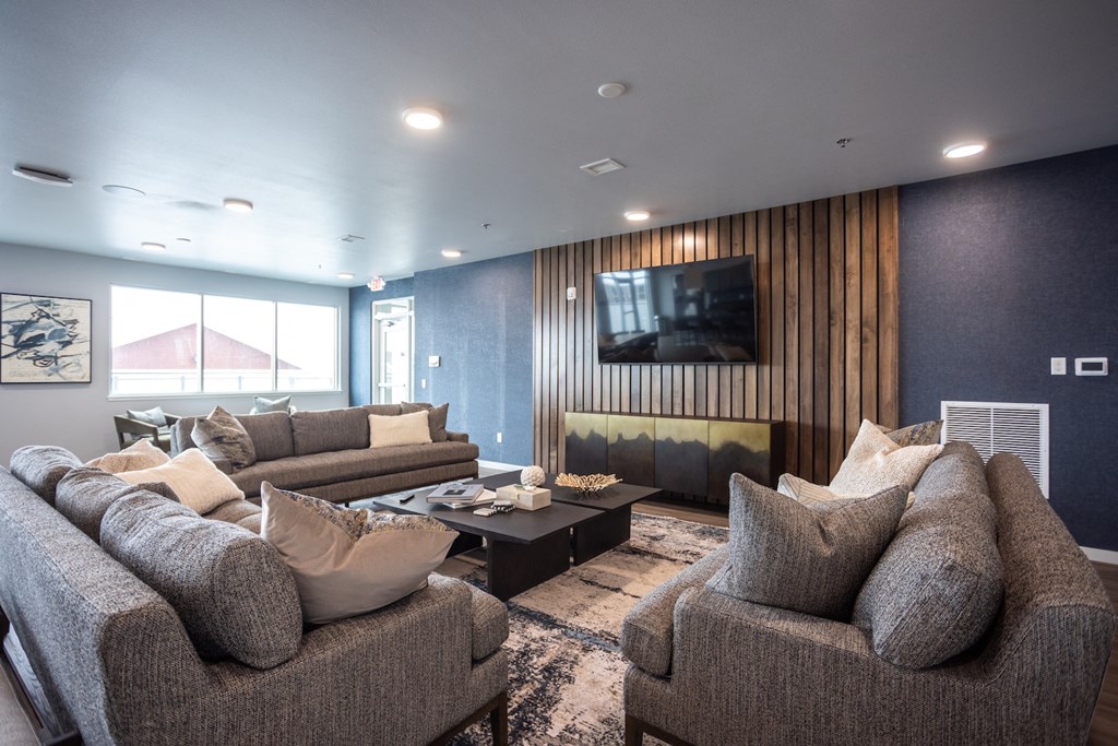 a large living room with couches and a tv