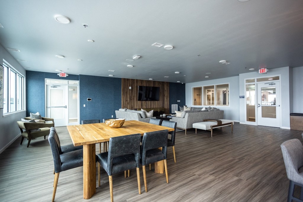 a dining room and living room with a table and chairs