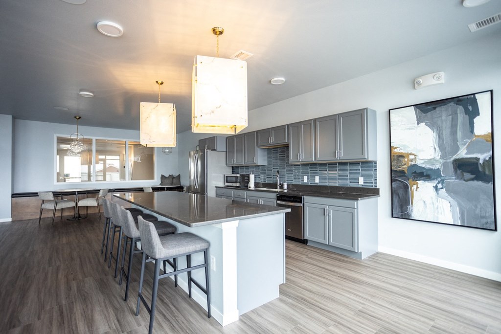 an open kitchen and dining area with a large island and bar stools